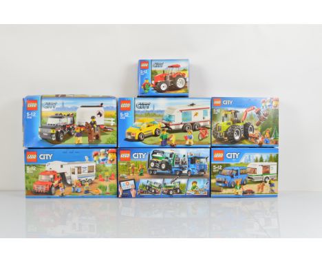 Seven boxed Lego City models, including Pickup and Caravan 60182 unopened, Van and Caravan 60117 unopened, Forest Tractor 601