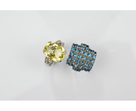 Two certificated silver dress rings, including a London blue topaz example of tablet design, ring size N and another lemon ci