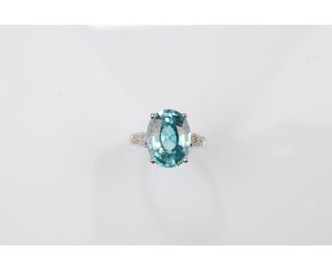 A certificated 9ct gold zircon and white topaz dress ring, the oval mixed cut blue zircon with white topaz set shoulders, the