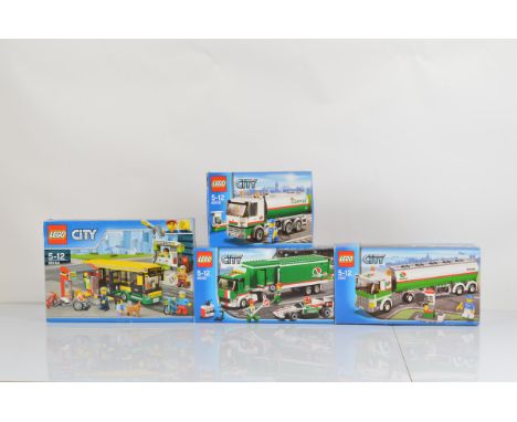 Four boxed Lego City models, including Bus Station 60154 opened with manuals unchecked, Tank Truck 3180 opened with manual an