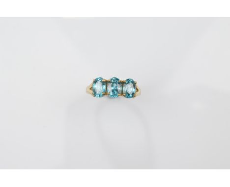 A certificated 9ct gold three stone blue zircon dress ring, the oval mixed cuts in claw settings all in yellow gold, ring siz