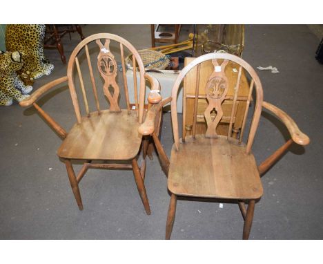 A pair of Ercol carver chairs with Prince of Wales feathers to the backs