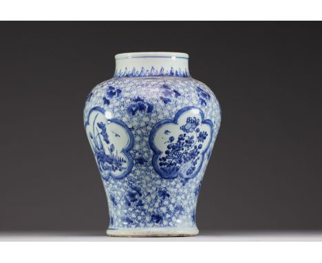 China - A white-blue porcelain baluster vase decorated with flowers, mugwort leaf mark in a double circle, Kangxi. Lid attach