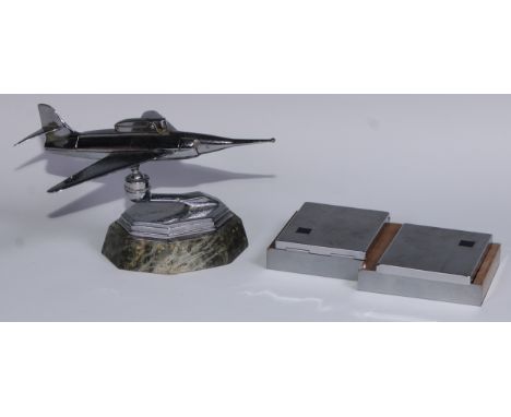 A mid-20th century chrome table lighter, as a fighter jet, marble base, 24cm long; an Art Deco style twin compartment cigaret