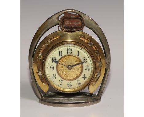 A late Victorian novelty timepiece, of equestrian interest as horseshoe within a riding stirrup, the 8cm clock dial with enam