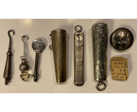 A silver cheroot holder case, Birmingham 1904; another; two miniature silver button hooks; silver pencil; etc 