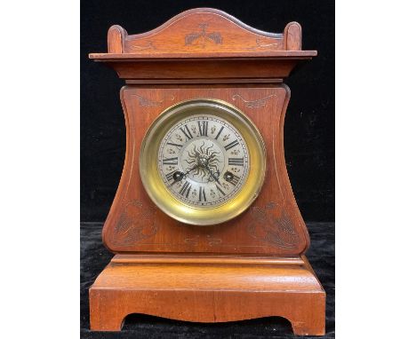A continental Art Nouveau mahogany mantel clock, arched case worked with tooled scrolling stems, silvered dial with Roman num