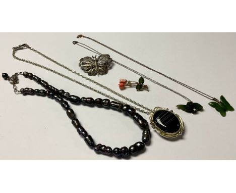 A silver Art Nouveau style necklace, set with a polished black lace agate cabochon, accented with 9ct gold roundels, marked s