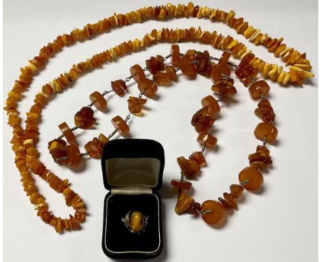 A silver and amber ring; an amber chip necklace; another amber type decorative necklace (3)