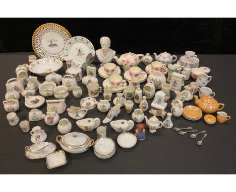 A collection of Goss and other crested china including fish basket, cow bells, pig, lamps, vases, sack bottle, etc; a Goss Pa