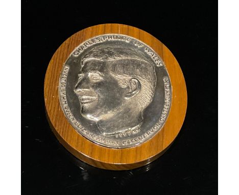 A Britannia silver commemorative oval plaque, inscribed in relief, Charles, Prince Of Wales, Invested By H.M. Queen Elizabeth