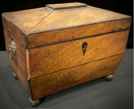 A Regency mahogany sarcophagus tea caddy, pair of lion mask loop handles, pair of covers, lined interior, four ball feet, 21c