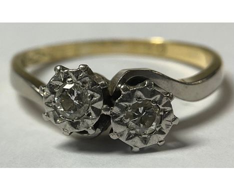 An 18ct gold and platinum two stone diamond crossover ring 