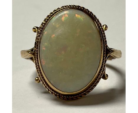 A gold coloured metal and opal ring, unmarked, 4.2g 