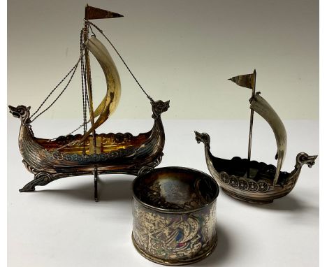 A Scandinavian silver gilt Viking ship, another smaller, marked Norge; a similar napkin ring, all unmarked, probably low grad