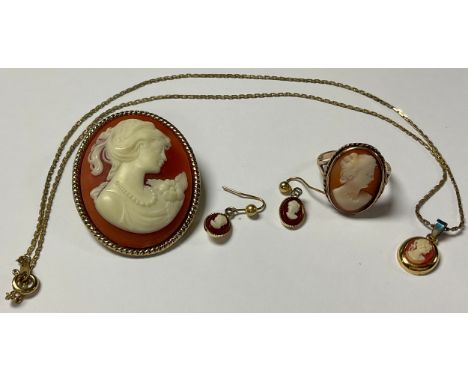 A 9ct gold carved shell cameo ring, size N, marked 9ct, 3.4g; a suite of costume cameo jewellery, scarf clip, pair of earring