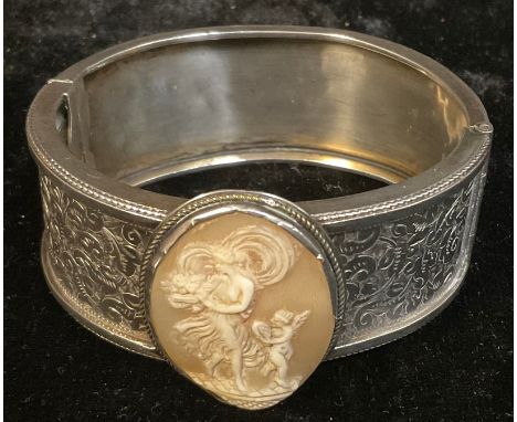 A shell cameo mounted silver coloured metal hinged bangle 