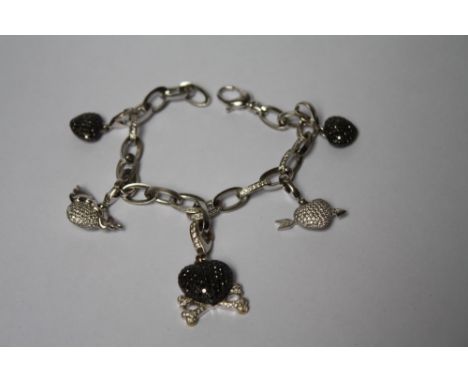 A THEO FENNELL OF LONDON 18CT WHITE GOLD AND DIAMOND BRACELET WITH FIVE ASSORTED JEWELLED CHARMS, the oval link bracelet set 