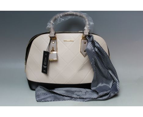 AN ALDO CREAM AND BLACK HANDBAG WITH TIED SCARF, zip fastening, W 39 cm