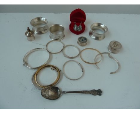 Three silver napkin rings, several silver bangles, a silver pill box by R. Carr with a fairy engraved to lid, another silver 