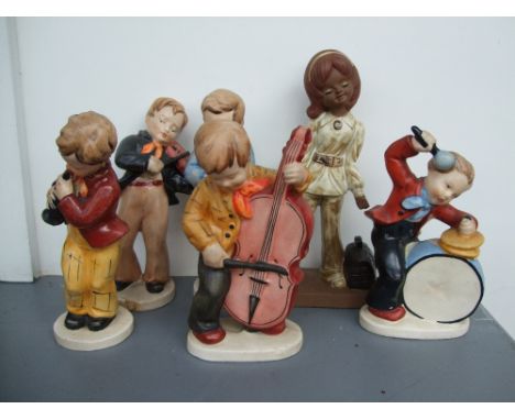 A collection of ceramic figurines playing musical instruments (6)