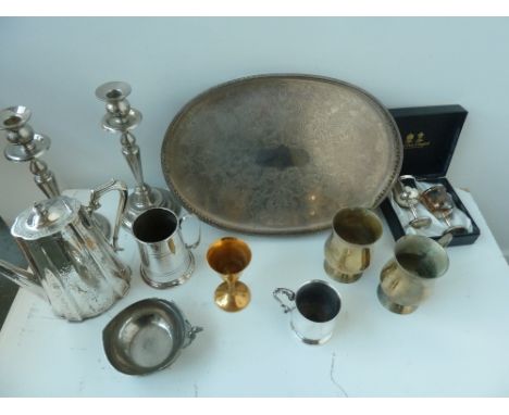 An early 20th century silver plated pierced gallery tray of oval form, a pair of silver plated candlesticks with turned bases