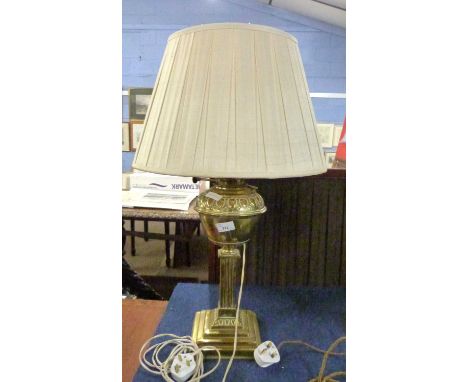 A brass oil lamp with shade