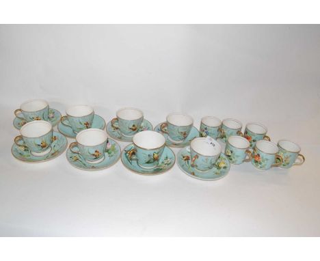 A 19th Century part tea set, cups and saucers and coffee cups, the light green ground decorated with flowers and butterflies