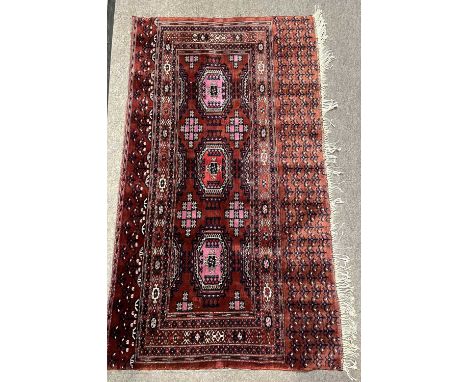 A Belouch wool wall hanging decorated with geometric patterns in red, blue and cream, 137cm wide (Item 67 on vendor list)