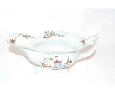 A Worcester sauce boat circa 1755, the moulded body with polychrome chinoiserie designs (spout broken and re-stuck)