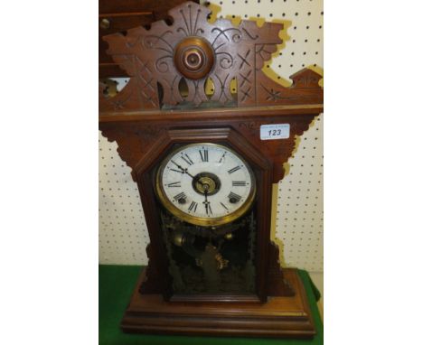 A late 19th Century walnut cased mantel clock, the eight day German movement with circular dial and gilded glass 