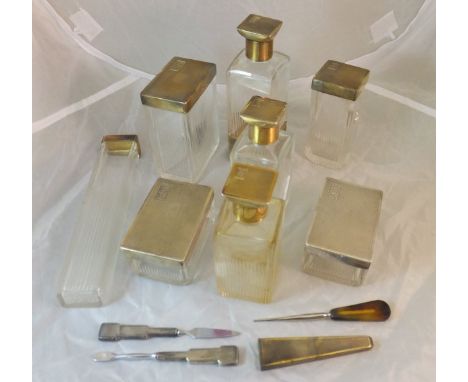 A collection of eight silver mounted Art Deco dressing table bottles with engine turned decoration and initialled "GK", toget