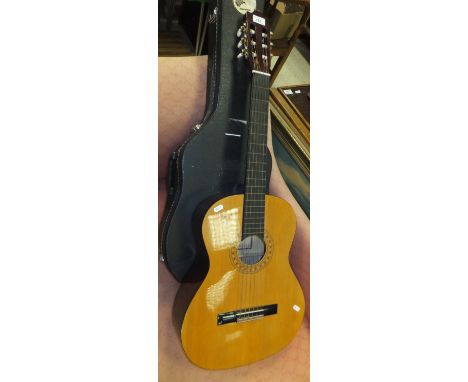 A Hohner MC-05 nylon stringed classical guitar, in hard case and a gilt framed print