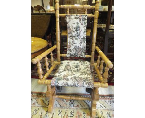 An American style child's rocking chair with tapestry upholstered seat and back