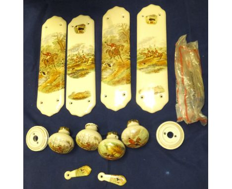 A collection of four ceramic door plates decorated with hunting scenes, together with four matching door knobs