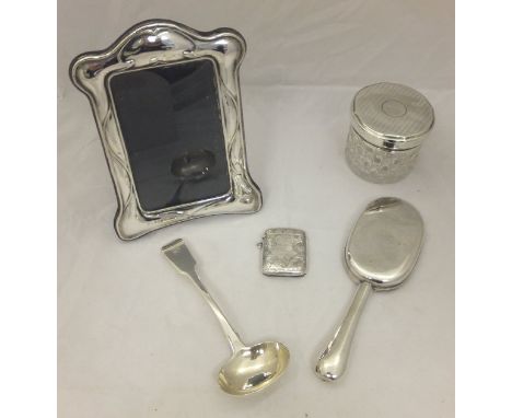 A box containing a silver vesta case with inscription "MMG to J Gould 1902" (Birmingham), a Georgian silver ladle (stamped WS