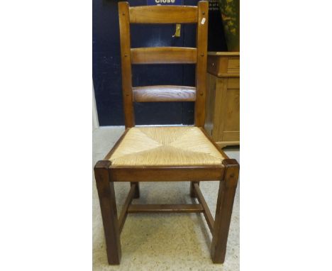 A set of ten oak rush seated ladder back dining chairs
