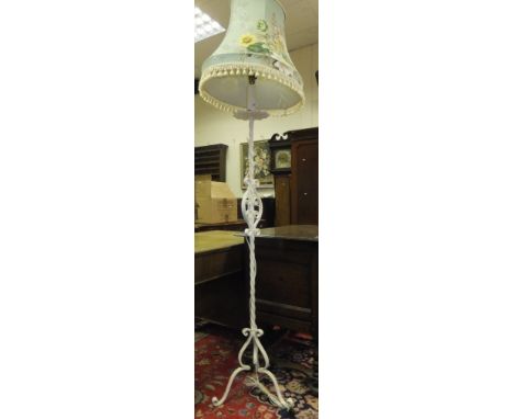A painted wrought iron standard lamp on tripod base, with shade