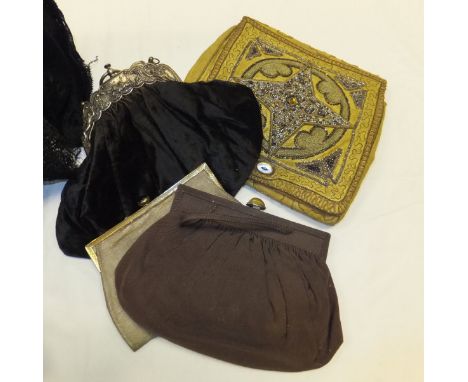 A brown crocodile case containing various lace panels, four evening bags, two with cabochon cut clasp, etc. together with thr