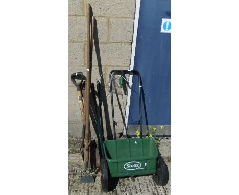 A Scotts Evergreen Seed Spreader and a small quantity of long handled garden tools