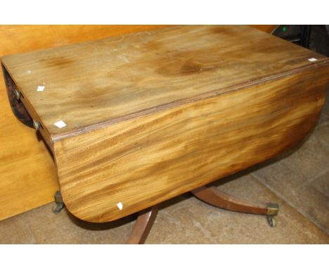 A Victorian revival mahogany Pembroke table, on central pedestal of four splayed feet terminating in brass casters, drawer to