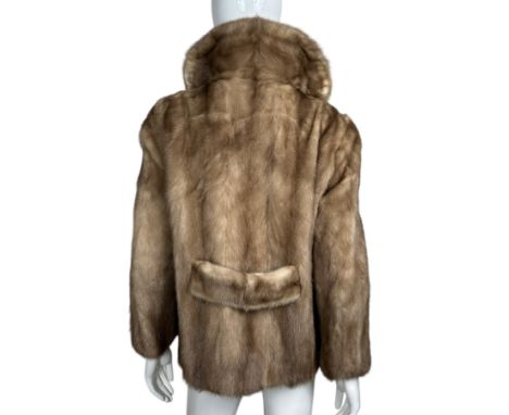 A vintage 1960s stranded mink fur jacket with notched collar and belt back. Taupe lining with jacquard flowers and set in poc