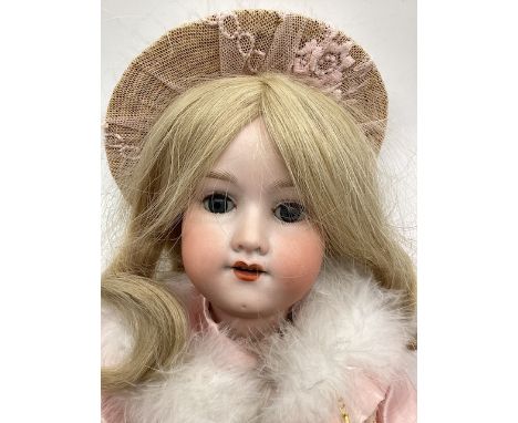 Antique doll ; German A A5M 390 21” bisque Head doll in pink later dress set -head has 2 fine scratch hairlines on the surfac