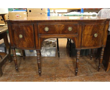 An early 19th century mahogany bow front sideboard with brass line inlay, frieze drawer flanked by cellarette drawer and cupb