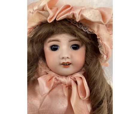 Antique 20&rdquo; French SFBJ bisque head doll model 60 ,20&rdquo; tall , brow glass eyes in later hand made Pink attire. (1)