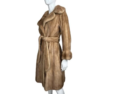 A vintage mink fur coat c1970s, the notched collar having deep lapels and the sleeves having bell shaped cuffs with decorativ