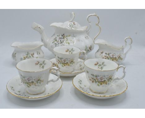 A collection of Royal Albert tea ware in the Haworth design to include a tea pot, 12 cups and saucers, a milk jug and a sugar