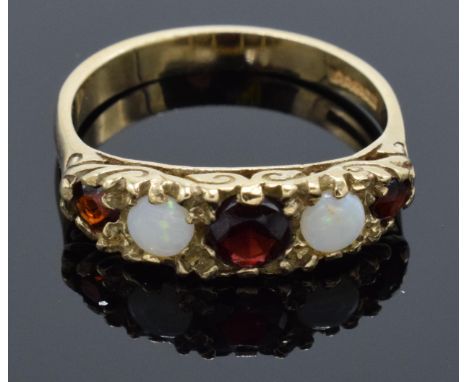 9ct gold ladies ring set with opal and garnet stones. 2.9 grams. Size O. 