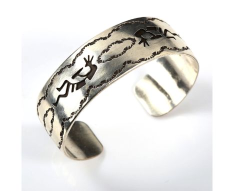 A stylised sterling silver cuff bangle, maker's marks JAC, Native American depicting Kokopelli - fertility deity, band width 