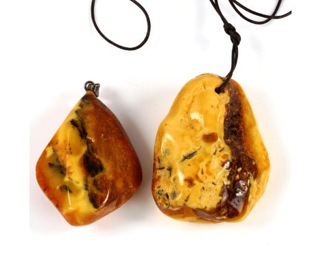 2 large Baltic amber pendants, largest height 55.6mm, 48.6g total (2)No obvious damage or repairs, only light surface wear 